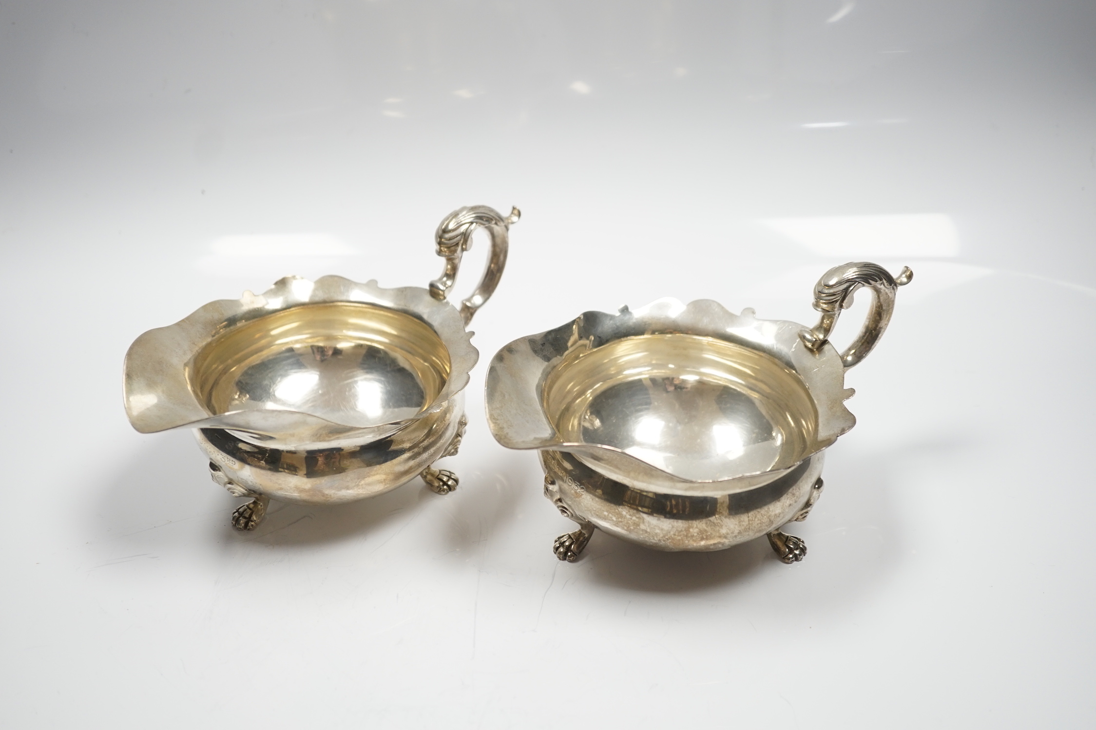 A pair of George V silver sauce boats, by Goldsmiths & Silversmiths Co Ltd, London, 1927 and 1932, length 18.2cm, 15.3oz.